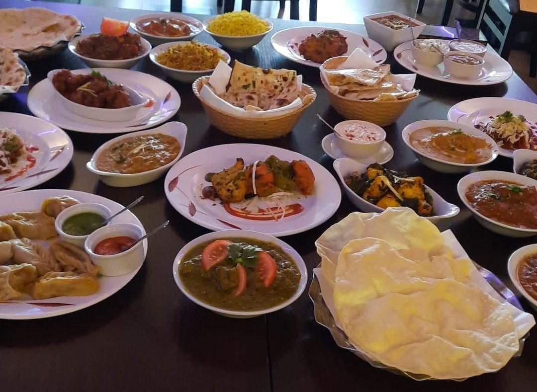 A spread of freshly prepared Indian dishes laid out for catering